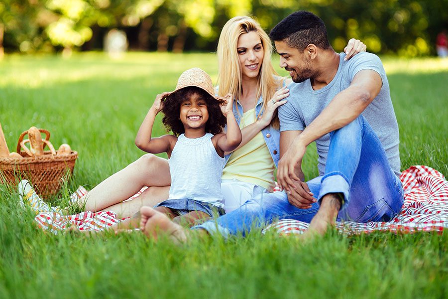 Personal Insurance - Picture of Lovely Couple With Their Daughter Having Picnic